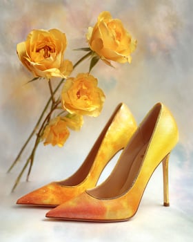 Yellow rose ombre stiletto heels with floral inspired gradient from warm yellow to burnt orange, shimmering texture, hyper realistic luxury fashion background photo