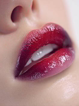 Dark tropical ombre lips close up with maroon inner layer, black midsection, and purple finish, rich glossy detail in open mouth beauty image photo