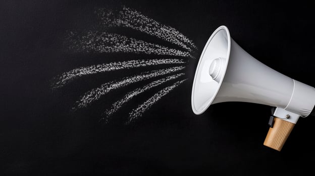 Close-up of a sleek white megaphone projecting chalk-sketched sound waves photo