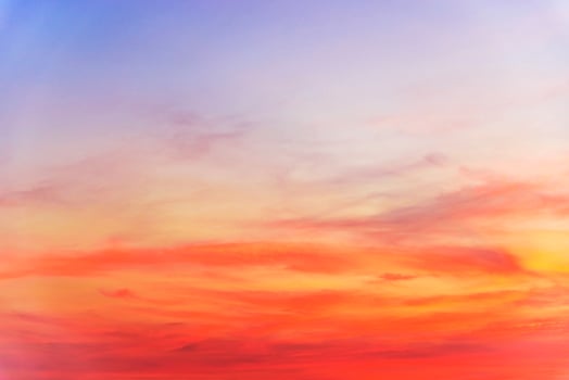 A beautiful sunset with a blue sky and orange clouds photo