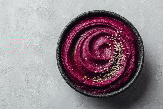 Beetroot Hummus with Olive Oil and Sesame Seeds on Gray Surface photo