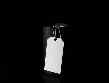 A white tag hanging from a black container photo