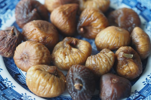 Dried figs arranged on a decorative plate photo