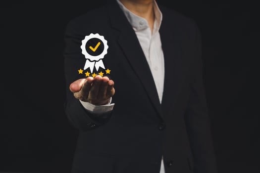 The best quality symbol assurance for a product, service on a hand businessman. photo