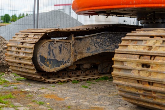 Close-up of excavator tracks on a construction site, showcasing their durability and traction. Ideal for construction and engineering projects, this visual highlights heavy equipment in action. photo