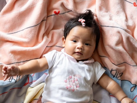 Newborn family joy at home soft blanket comfort indoor setting heartwarming viewpoint cherishing precious moments photo
