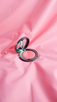 Open Pink Blush Compact on Soft Pink Fabric Background photo