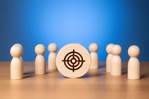 Focus Target Concept with Wooden Figures and Symbol on Blue Background photo