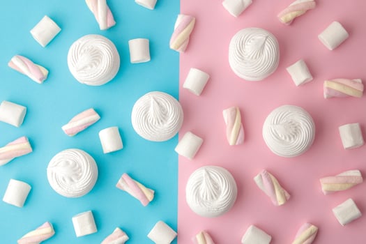 Background of sweet white marshmallows and small marshmallows on a bright trendy pink and blue background. Sweets. dessert. view from above photo