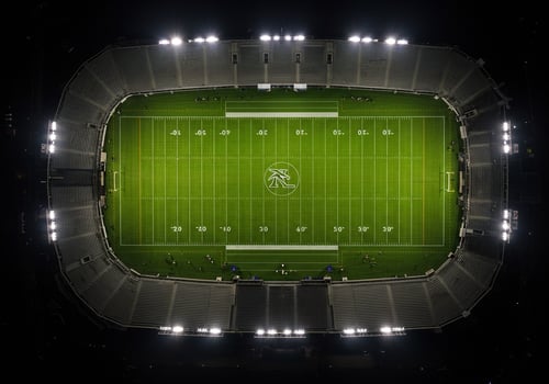 Aerial view of a football stadium at night, illuminated by stadium lights photo