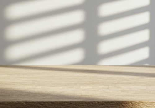 A wooden table surface with light and shadow patterns photo