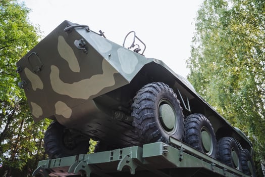 A stateoftheart Military AllTerrain Vehicle featuring an advanced Camouflage Design is prominently displayed under the bright and clear sky, showcasing its versatility and tactical capabilities photo
