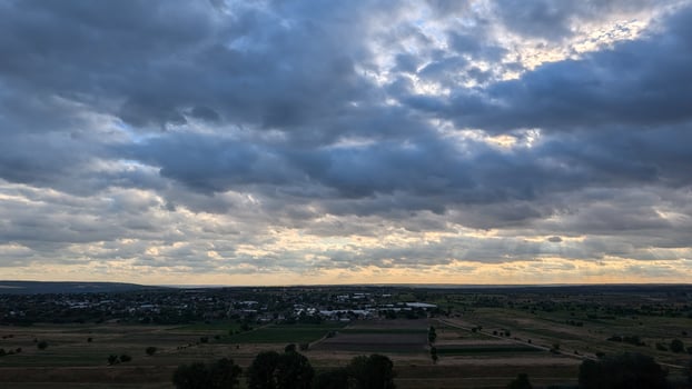 Dramatic Cloudy Skies Stretching Over the Beautiful Countryside Landscape at Dusk photo
