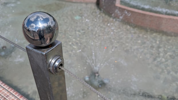 A CloseUp of a Beautiful Fountain Showcasing Stunning Reflections and Various Water Features photo