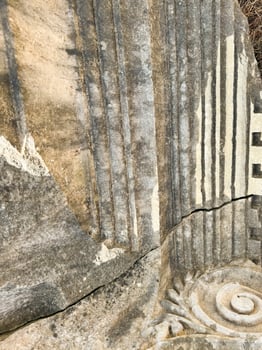 Ancient stone carvings showcasing intricate designs in a secluded outdoor setting photo