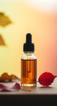 Autumnal Harmony Glass Bottle with Golden Serum a Red Leaf and Subtle Hints of Changing Seasons in a Beauty Still Life photo
