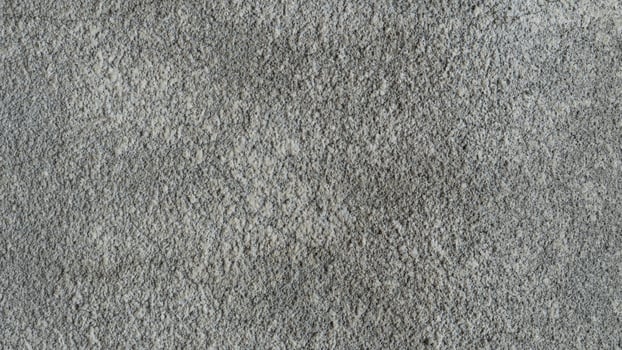 Abstract grey textured background showing a rough grainy surface. Excellent for minimalist designs, backdrops or to add subtle depth. photo