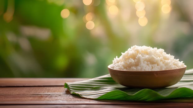 Bowl of white rice on a leaf photo