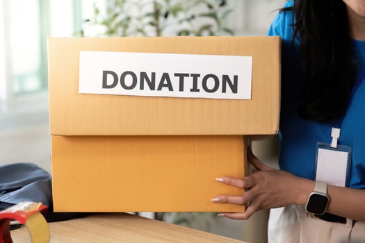 Volunteer carrying donation box, promoting community support photo