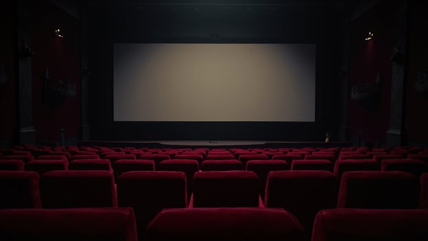 Empty vintage movie theater interior with red velvet seats and a blank screen ready for a film photo