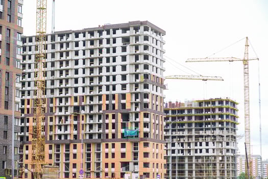 Moscow, Russia, 18.06.2025 Apartment buildings under construction with tower cranes. Real estate development and modern city growth concept. Urban housing. photo