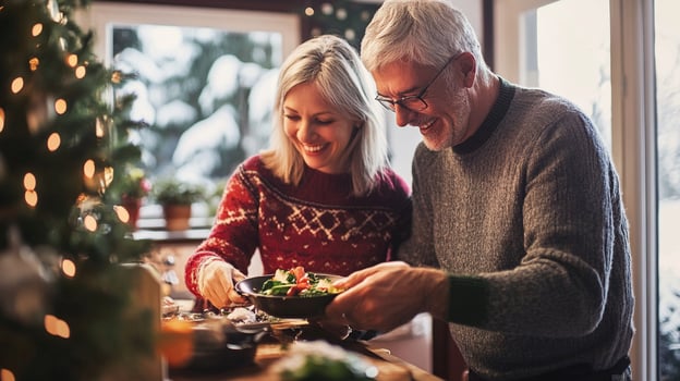 Couples sharing joyful moment while cooking together in winter photo