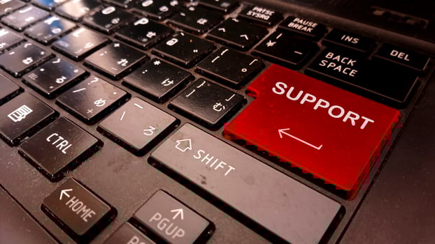 A red support button is on a laptop keyboard photo