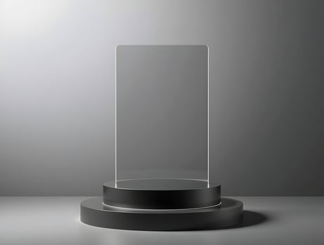 A glass display stand on a table with a light photo