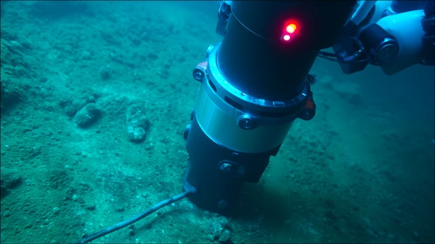 Deep sea mining robot operates on ocean floor extracting polymetallic nodules. Underwater industrial machine harvests cobalt, manganese, rare earth metals for battery production. photo