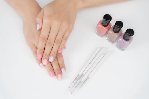 Woman show beautiful nail after receive care service by professional Beautician Manicure at spa centre. Nail beauty salon use nail file for Glazing treatment manicurist make nail to beautiful. photo