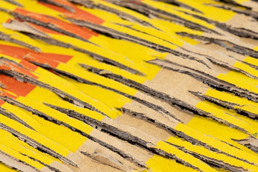 Abstract background of brown cardboard with cuts and yellow and red ink patches. Recycling, shipping concept photo