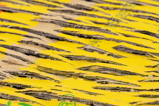 Abstract background of brown cardboard with cuts and yellow patches. Recycling, shipping concept photo