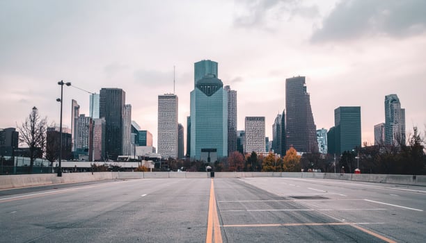 A city skyline with a road in the middle photo