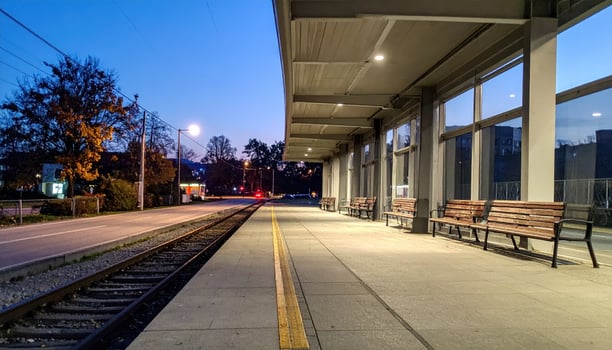 A train station with benches and a train track photo