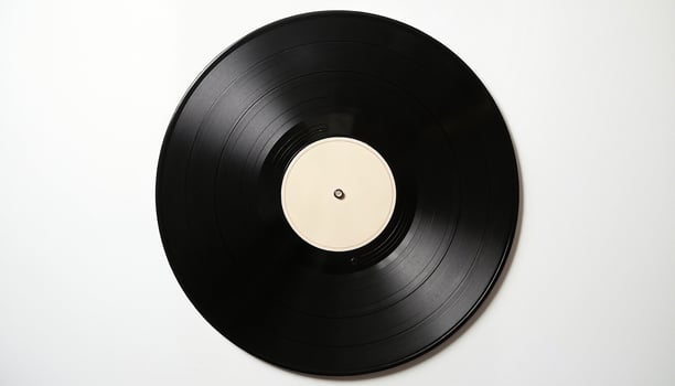 A pristine black vinyl record disc is showcased against a stark white background. photo