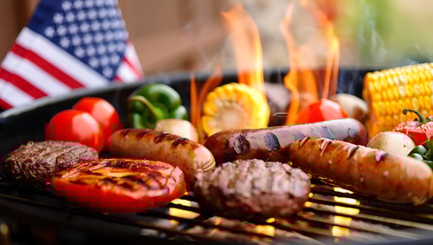 Vibrant BBQ Grill with Burgers, Sausages, and Vegetables Cooking over Flames with American Flag photo