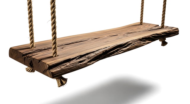 Rustic wooden plank swing hanging by thick ropes photo