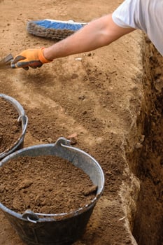 A Close up of a Hand with a Glove at an Archaeological Dig. Concept The human touch in historical discovery. photo