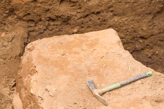 The Tool of an Archaeologist Resting on a Discovery. Concept A moment of pause in the process of revelation. photo