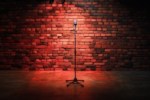 Minimalistic stage setup with lone microphone and rustic brick wall in background. Ideal for use in promotional materials for open mic nights, live events or artistic posters photo