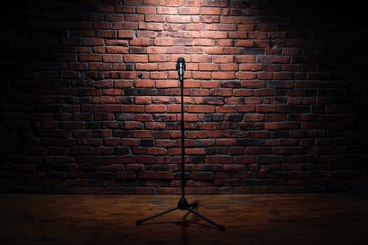 quiet performance space with microphone and empty stage, surrounded by industrial brick wall. Suitable for use in flyers, digital banners or content about performing arts and expression photo