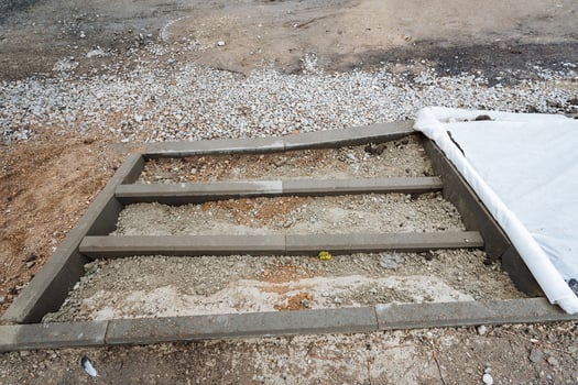 At this moment, a concrete staircase is actively being constructed in a gravel area that has been very carefully selected for this specific purpose, ensuring stability and durability for future use photo