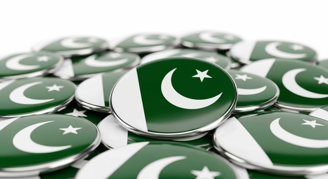 Closeup of Numerous Pakistan Flag Badges. photo