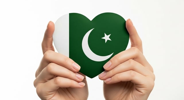 Female hands gently holding a heart with the national flag of Pakistan on a white background. photo