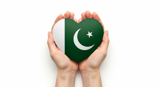 Hands Holding Pakistan Flag Heart Shape White Background. photo