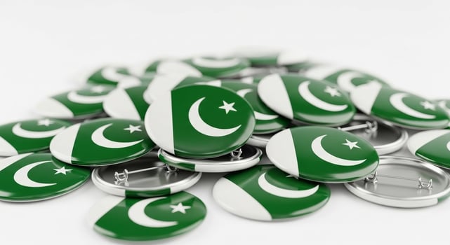 Pile of Pakistan Flag Badges on White Background. photo