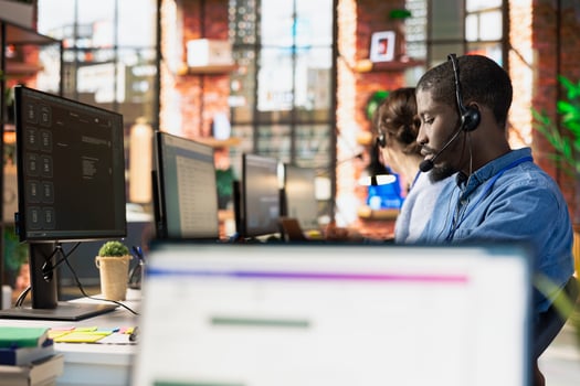 Call center agent using AI chatbot to provide multilingual support to customers. Customer support workplace employee leveraging AI to translate clients interactions in real time photo