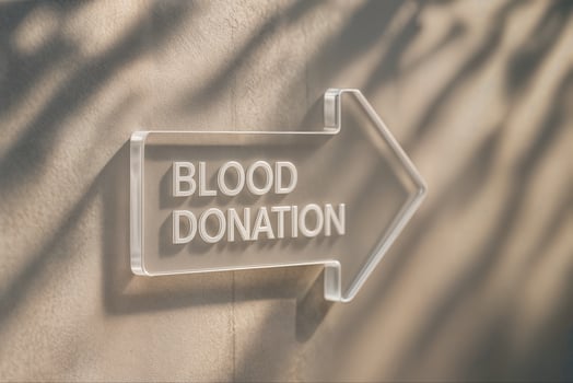 Acrylic Arrow Sign with Blood Donation Text on Wall Highlighting Shadow and Light Play for Modern Healthcare Campaigns photo