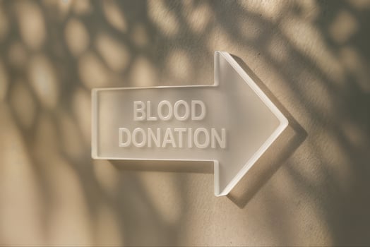 Acrylic Arrow Pointing to Blood Donation Center With Shadow Play and Minimalist Design Emphasizing Healthcare and Community Support photo