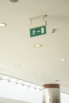 Emergency exit sign guide in a modern building hallway photo